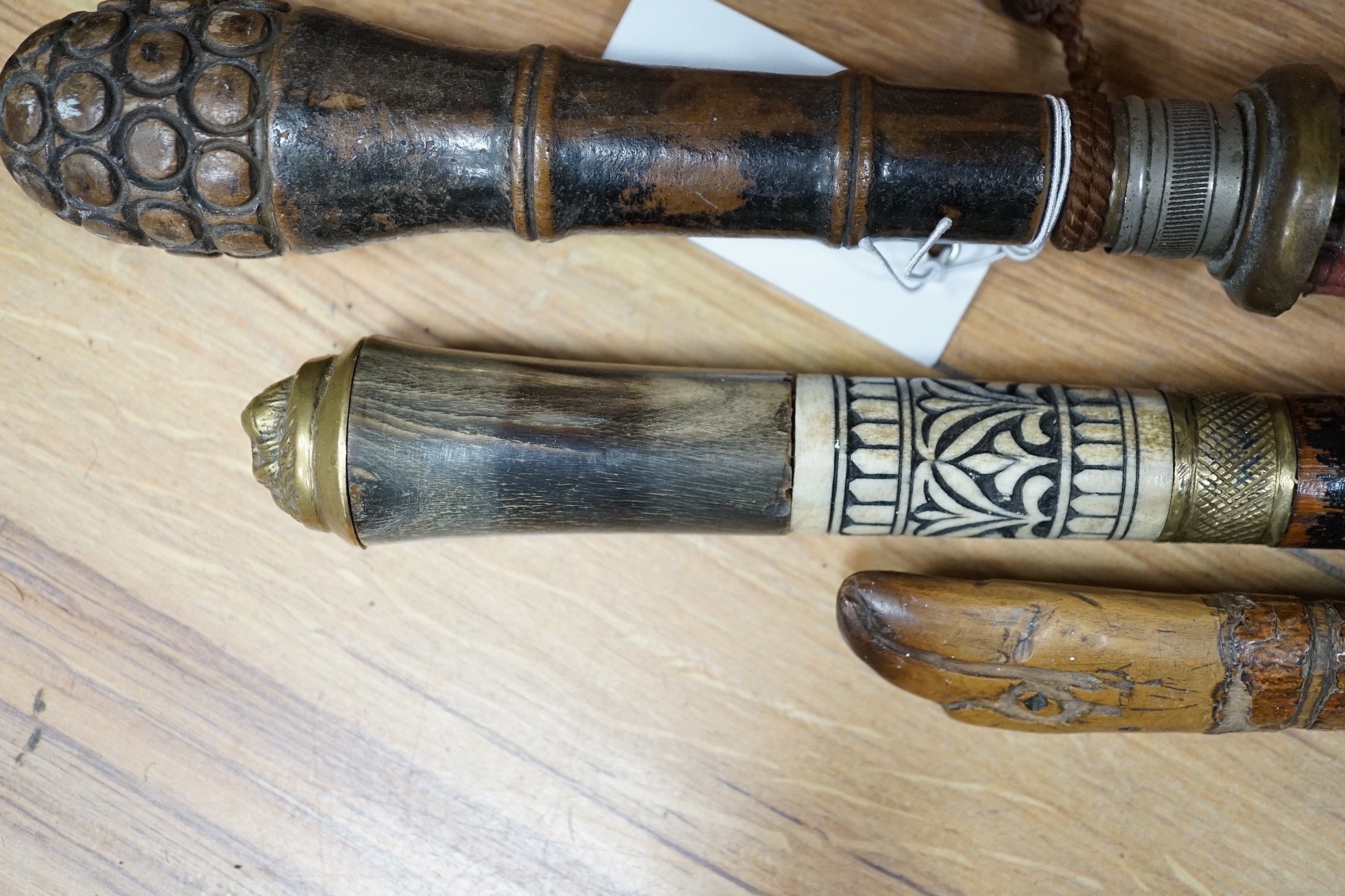 A bone and brass mounted ebonised sword stick, a Chinese umbrella and a cane